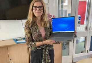 Julie Bayford, CEO of Phoenix Group, with the laptop.